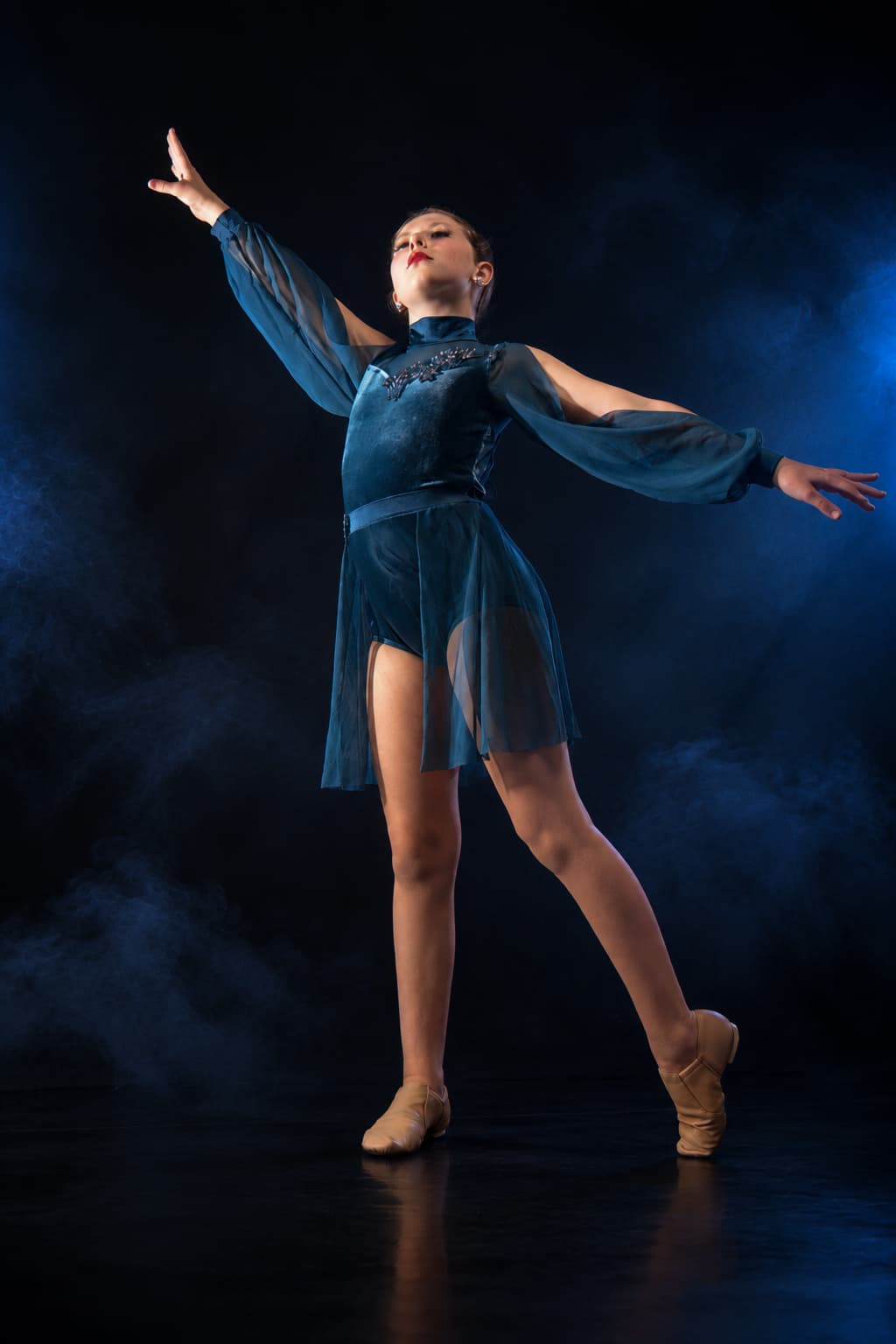 Full-length dancer portrait with blue smoke and dramatic lighting
